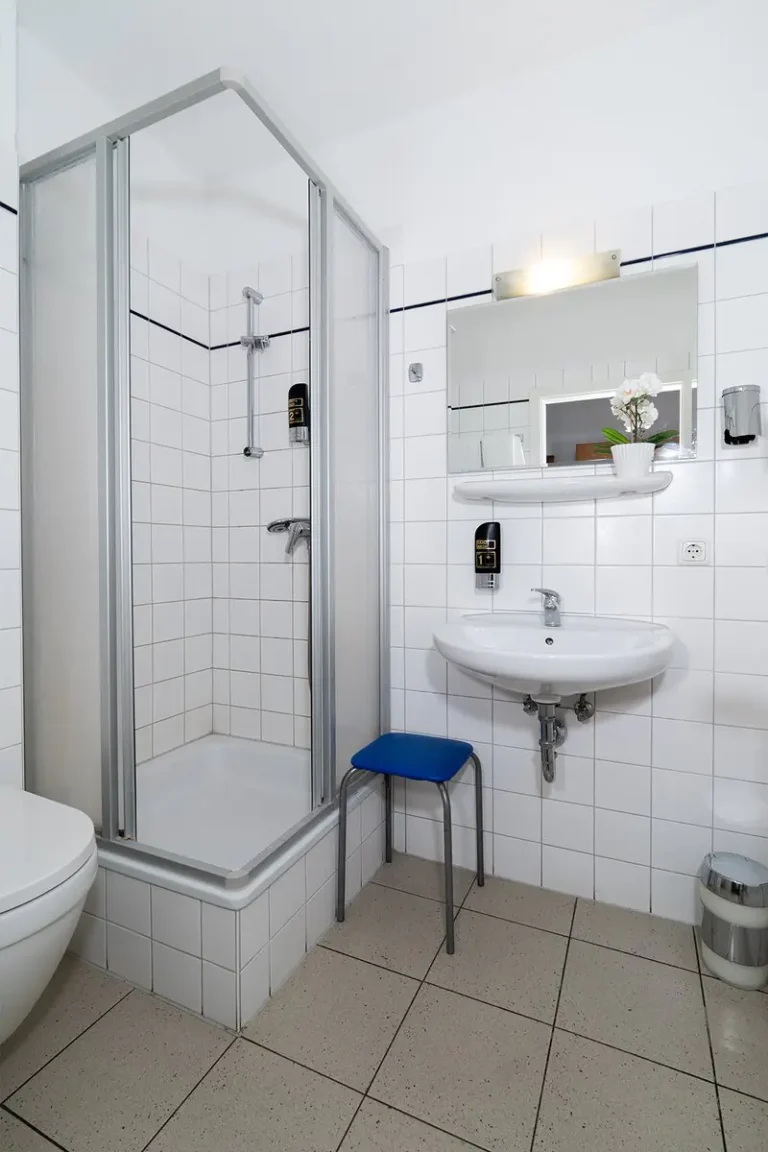 Waschbecken und Dusche im Badezimmer von Zimmer 4 Pension zur Schleuse Kleinmachnow